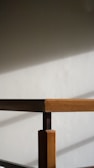 Softly lit wooden table showcasing minimalist design and natural grain patterns.