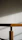 Close-up of a sleek wooden table with smooth edges and natural grain, bathed in soft daylight.