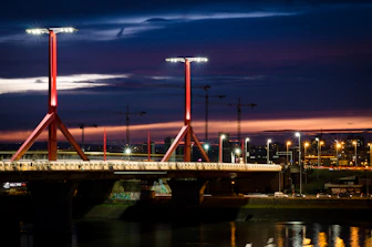 A dynamic industrial bridge construction site at sunset, symbolizing infrastructure development.
