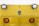 A close-up view of the front of a yellow industrial vehicle with two round headlights and two orange reflectors. The surface features a diamond plate pattern and a logo that reads 'Taylor Dunn' in the center.