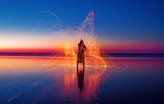 person with light effect surrounded with water