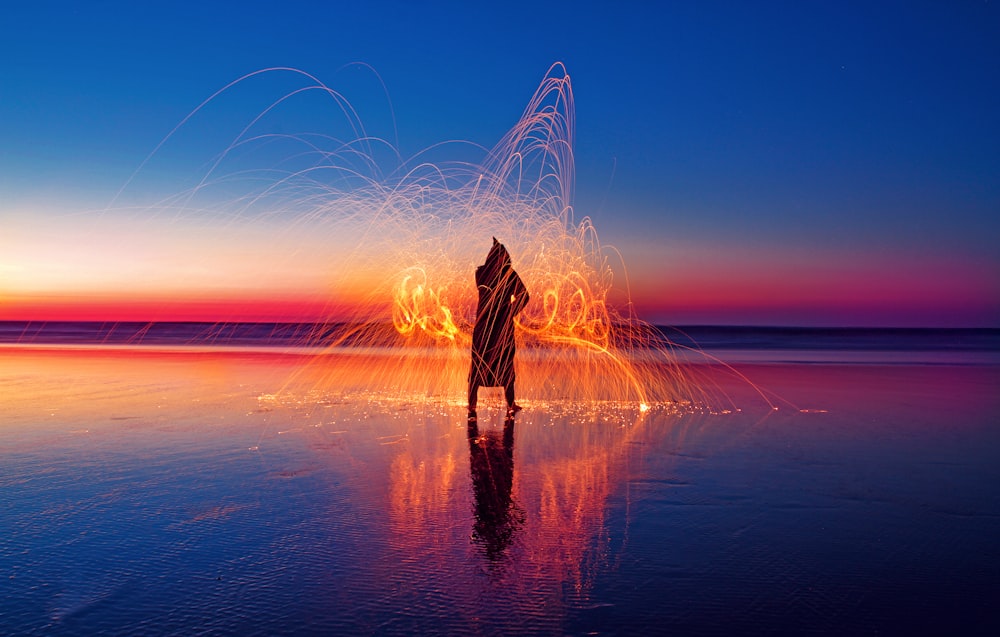 person with light effect surrounded with water