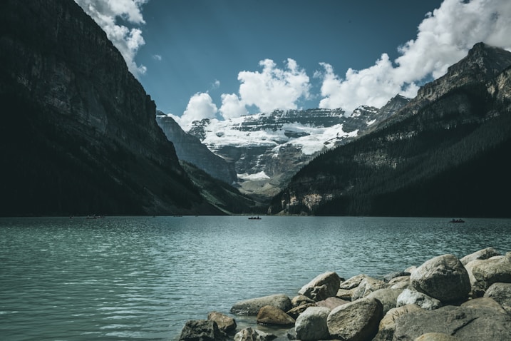 landscape photography of body of water between mountains