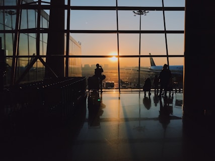 A serene airport terminal with travelers checking in and waiting for their flights.