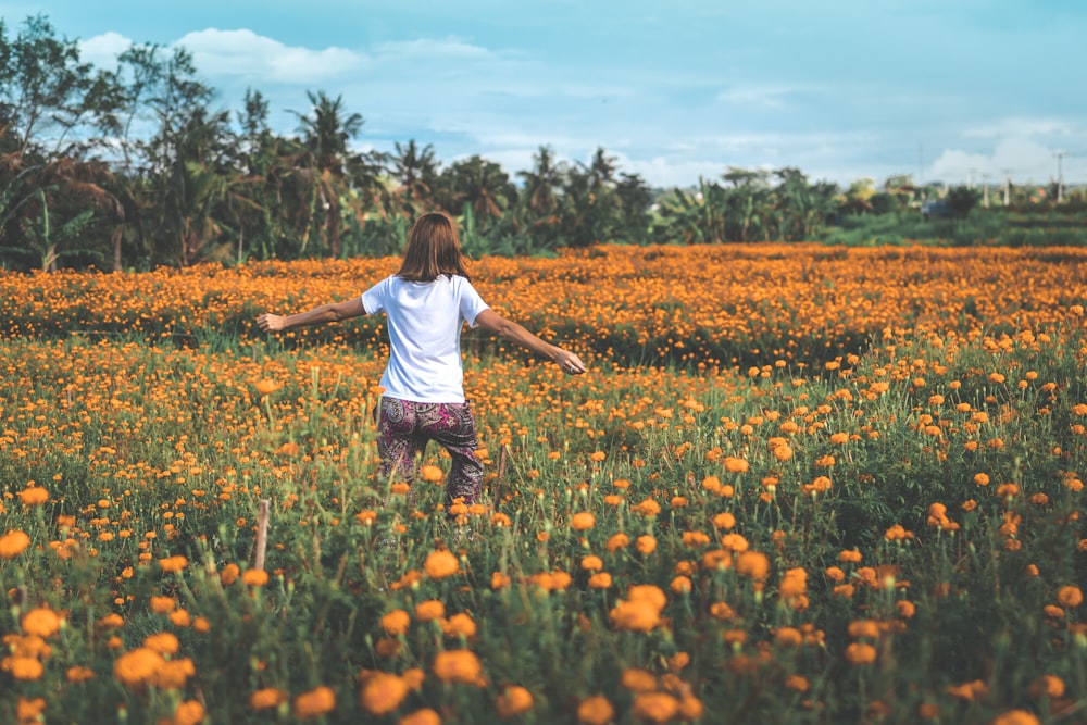 Mujer de pie en el jardín de flores de naranjo