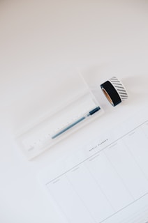 white ruler with ruler in box beside adhesive tapes