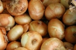 Close-up of golden onions stacked neatly in export boxes.