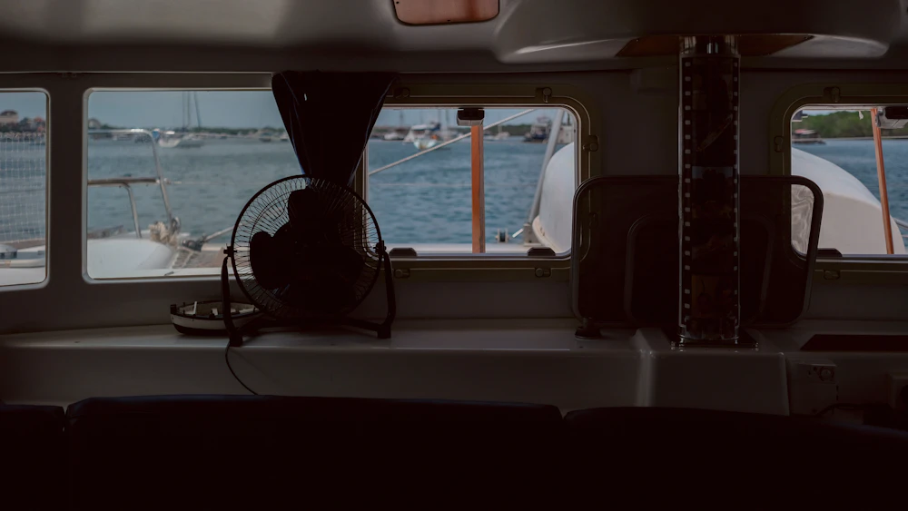 Halcyon wheelhouse — helm position with open sea windows