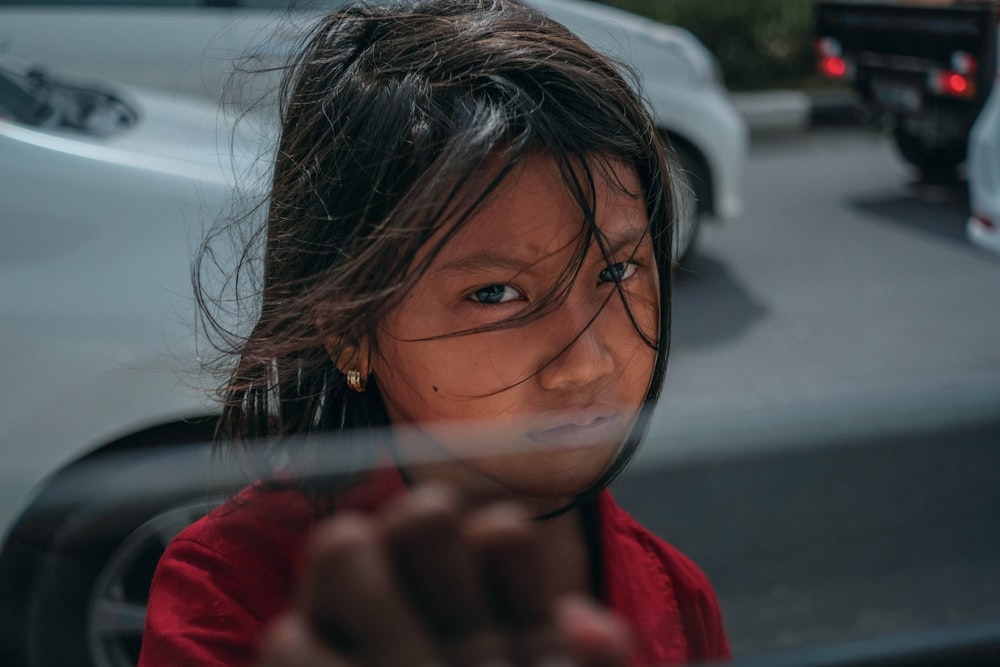 girl standing near vehicle