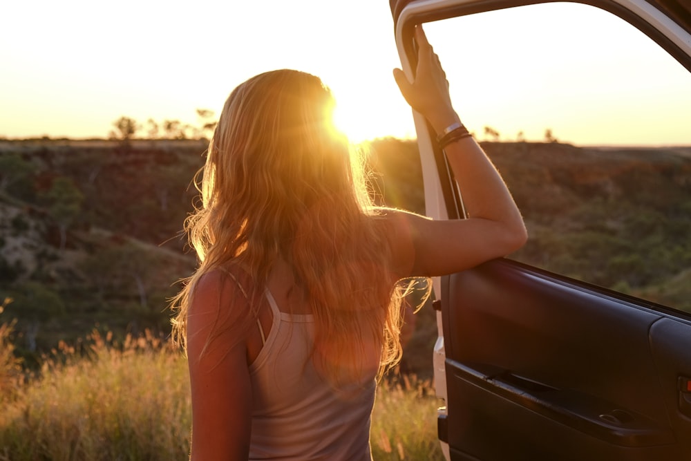 woman holding vehicle door