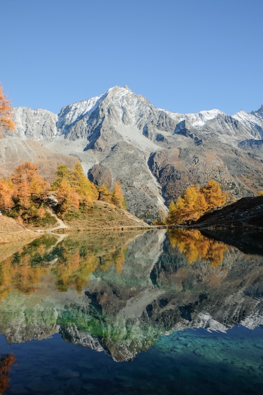 gray mountain beside body of water in Arolla Switzerland