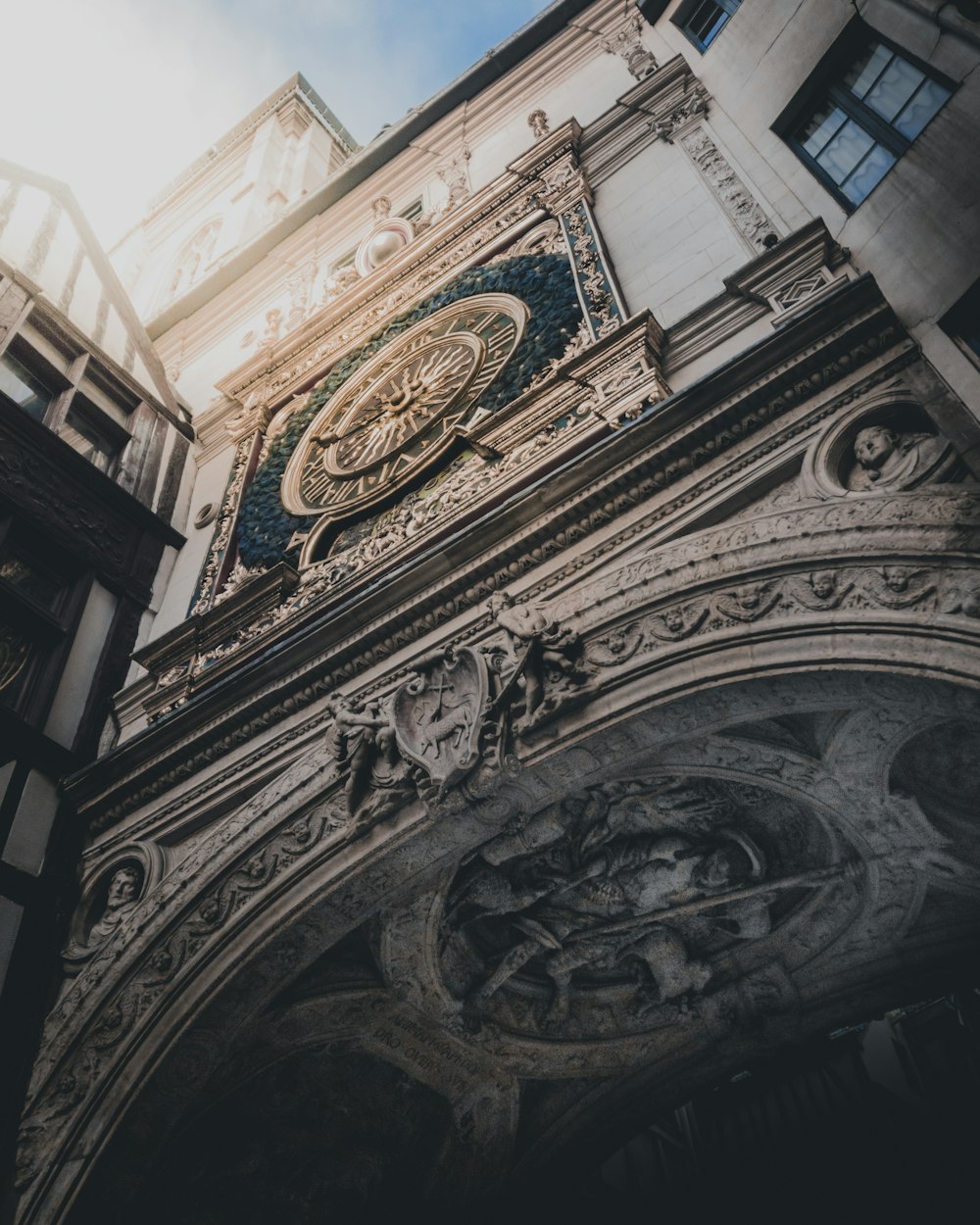 low-angle photo of gray concrete building with clock