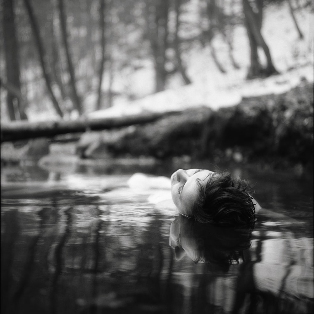 woman floating of body of water