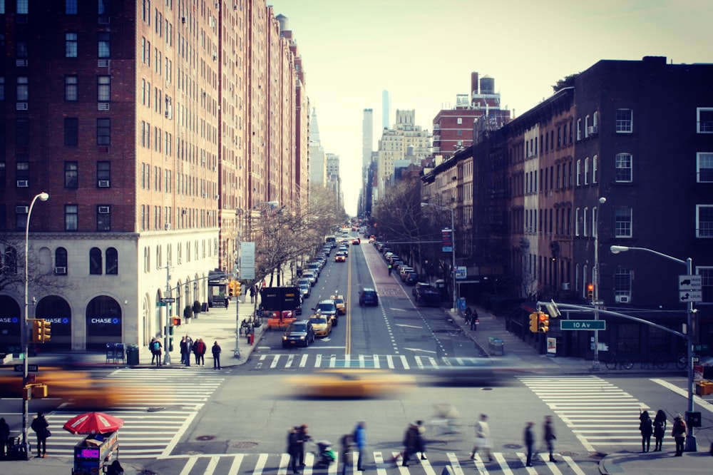 people crossing on road near buildings