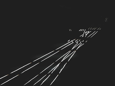 Silver highlights tracing sharp geometric shapes on dark background.