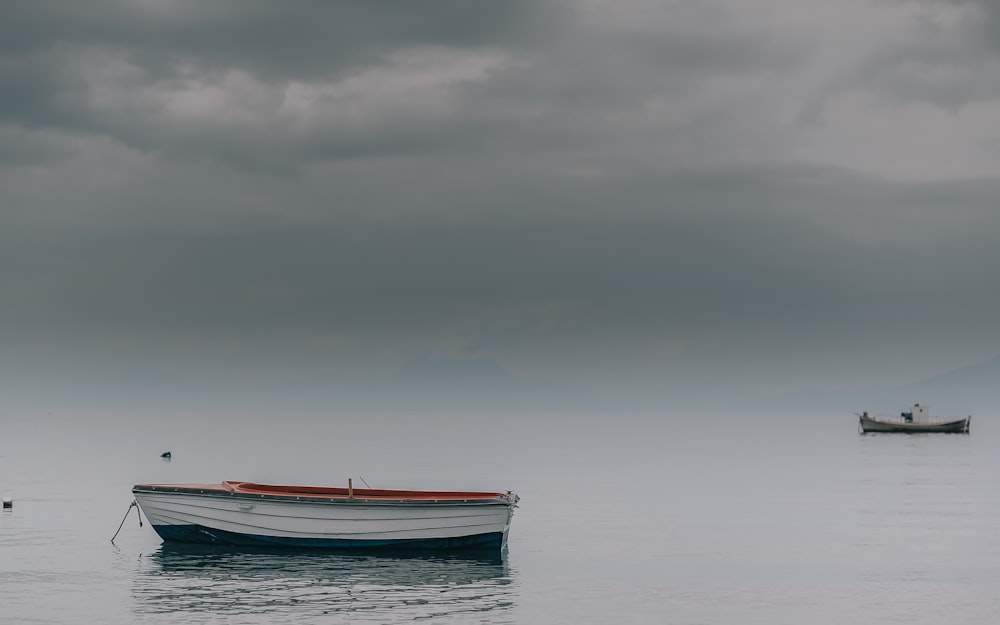 white canoe on calm sea at daytime