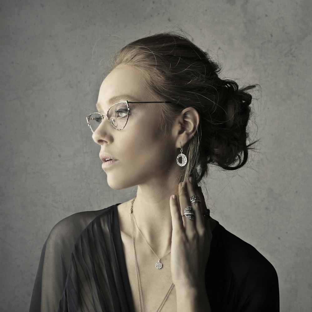 woman holding her neck while facing left