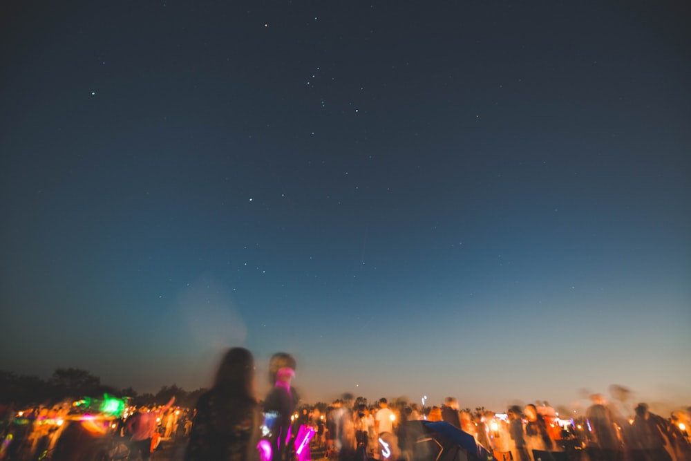 people standing on land at night time