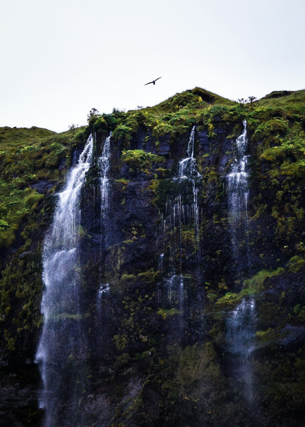 time lapse photography of flowing multi-tier waterfall