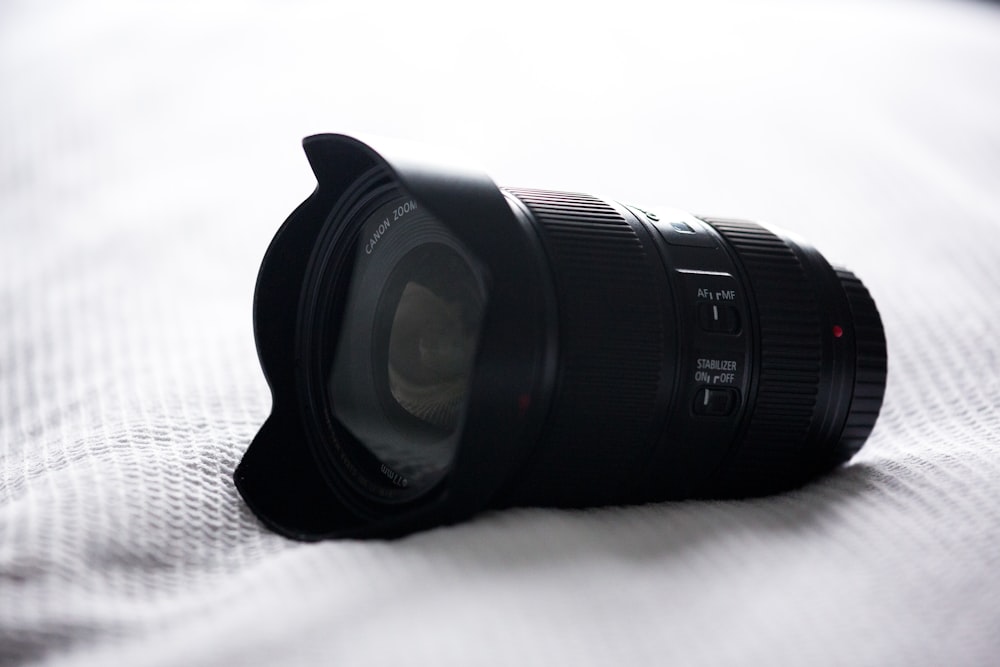 black camera zoom lens on white top textile