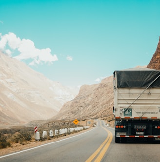 white and black truck near mountain at daytime