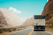 A moving truck driving through a scenic Canadian landscape on a long-distance route.