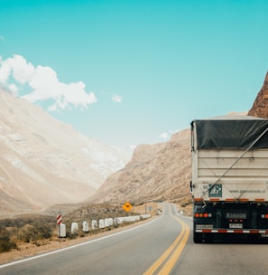 white and black truck near mountain at daytime