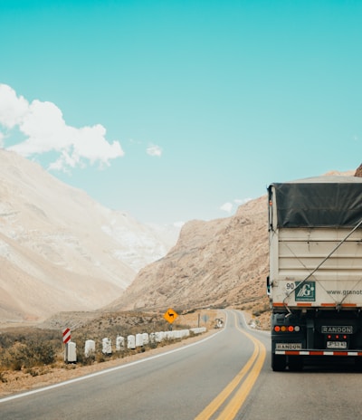 white and black truck near mountain at daytime