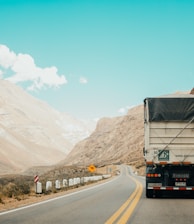 white and black truck near mountain at daytime