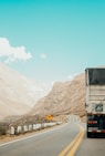 white and black truck near mountain at daytime