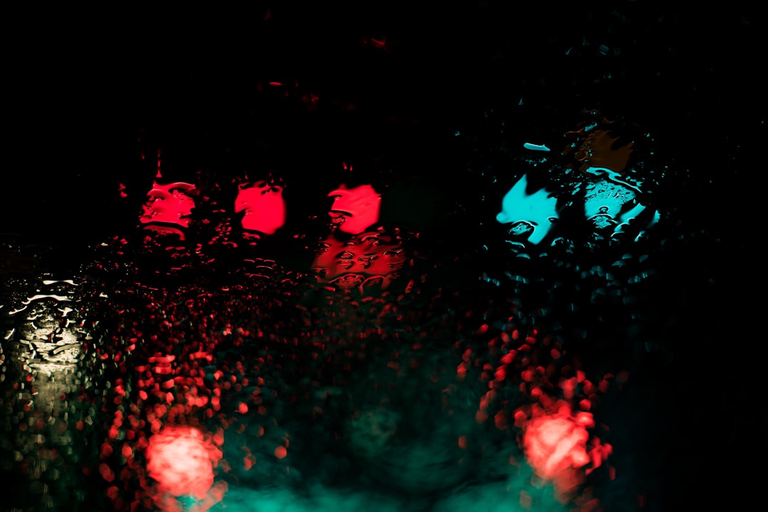 red and blue lights reflecting through body of water at nighttime