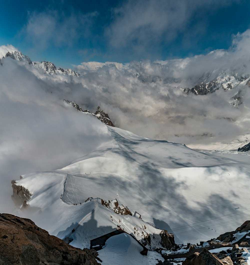 bird's eye photography of mountain surrounding snow