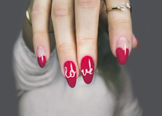 selective focus photography of woman's pink manicure