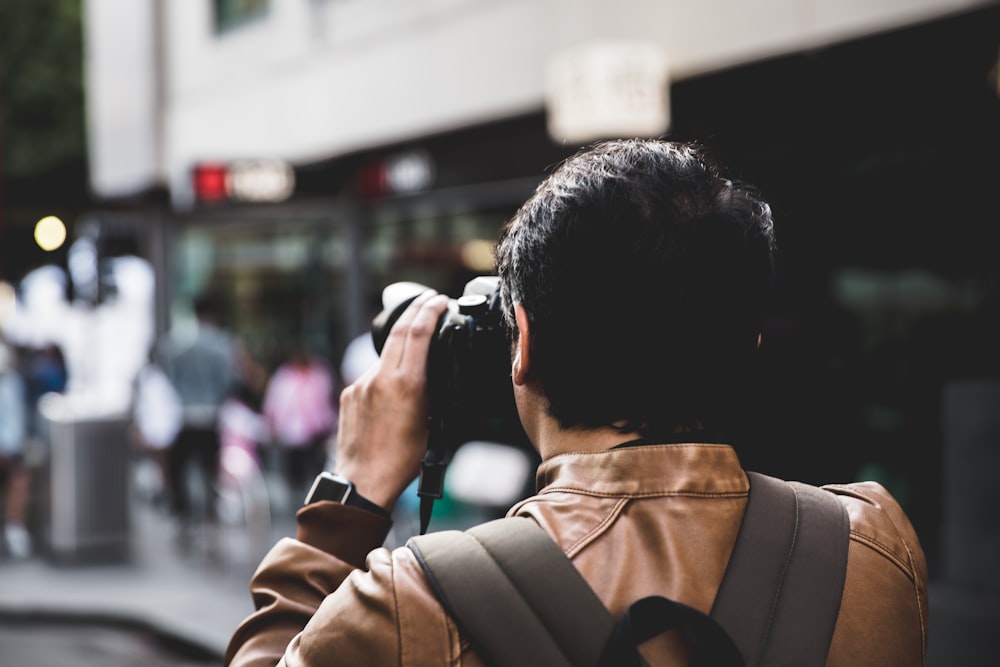 man using DSLR camera