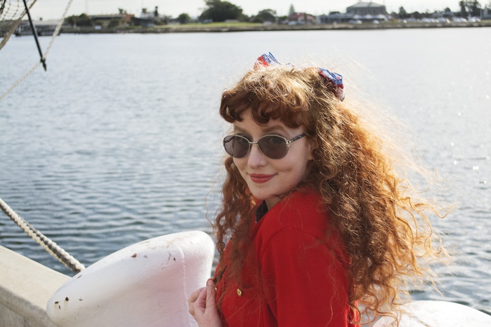 woman in red long sleeve shirt wearing black sunglasses