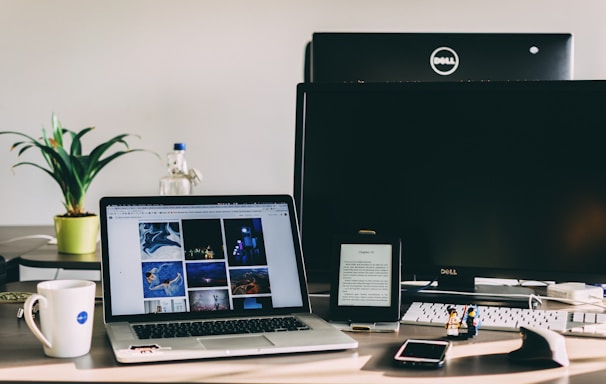 black and gray laptop computer near flat screen monitor