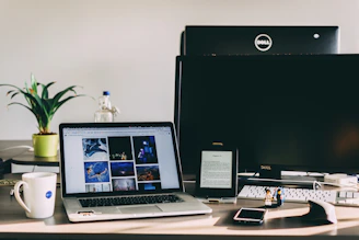 A sleek, minimalistic workspace with a laptop displaying vibrant stock photos on the screen, surrounded by soft natural light.