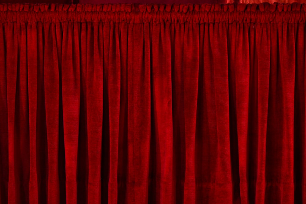 closeup photo of red rod pocket curtain