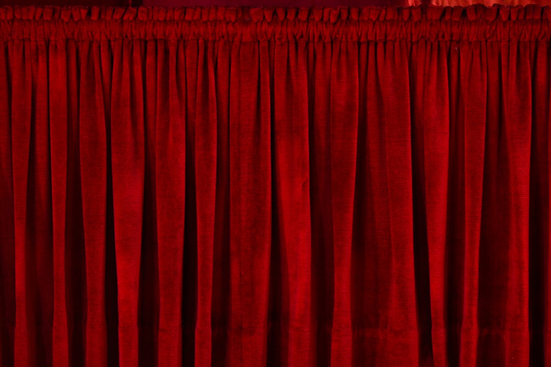 closeup photo of red rod pocket curtain, the curtain