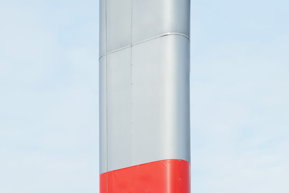 a red and white pole against a blue sky