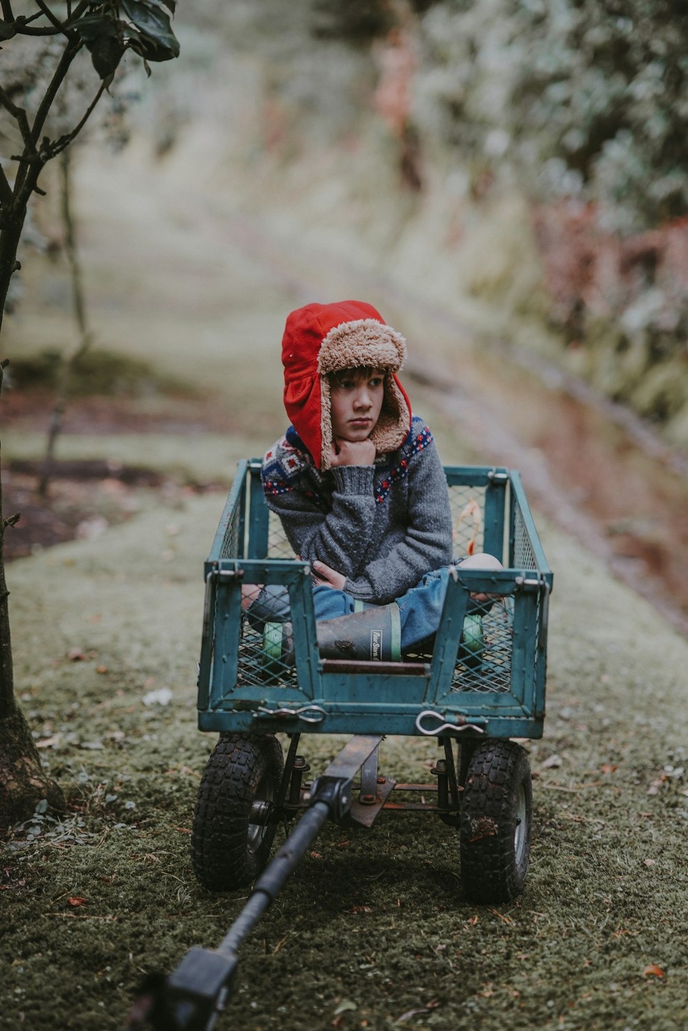 girl riding on utility trailer