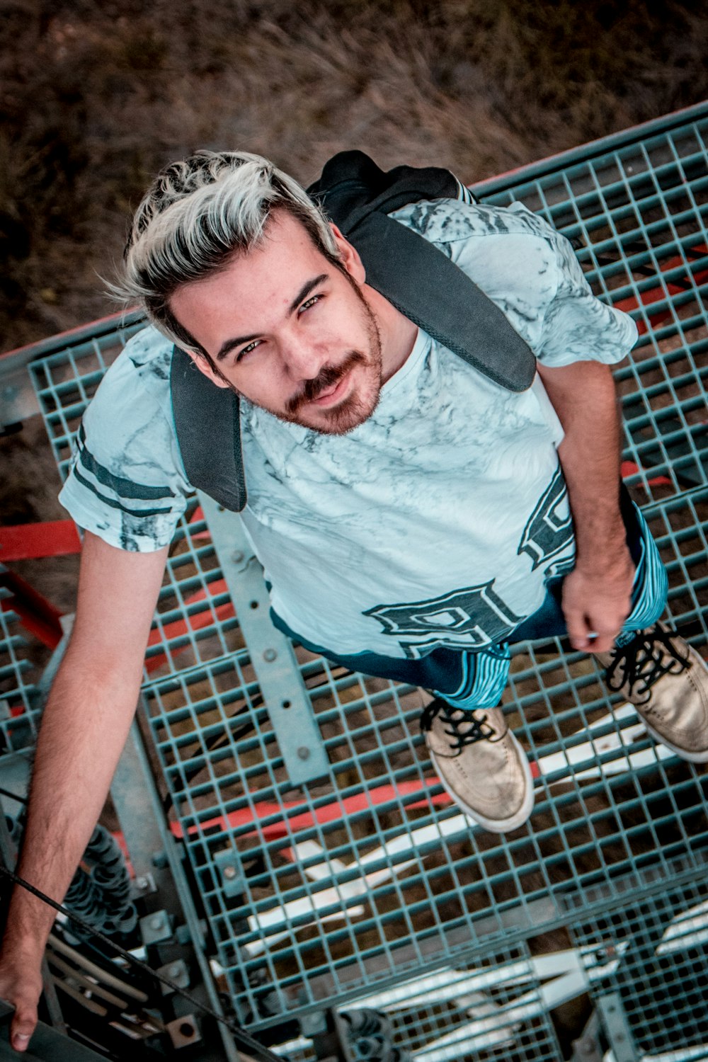 man standing on tower looking up