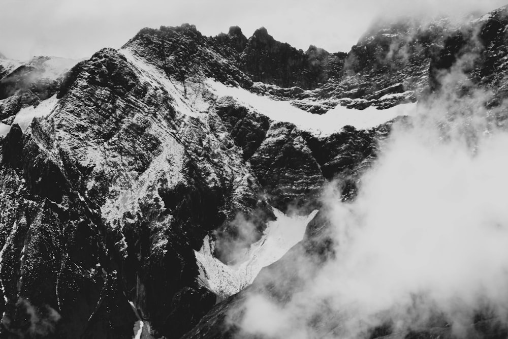 grayscale photography of glacier mountain with fogs