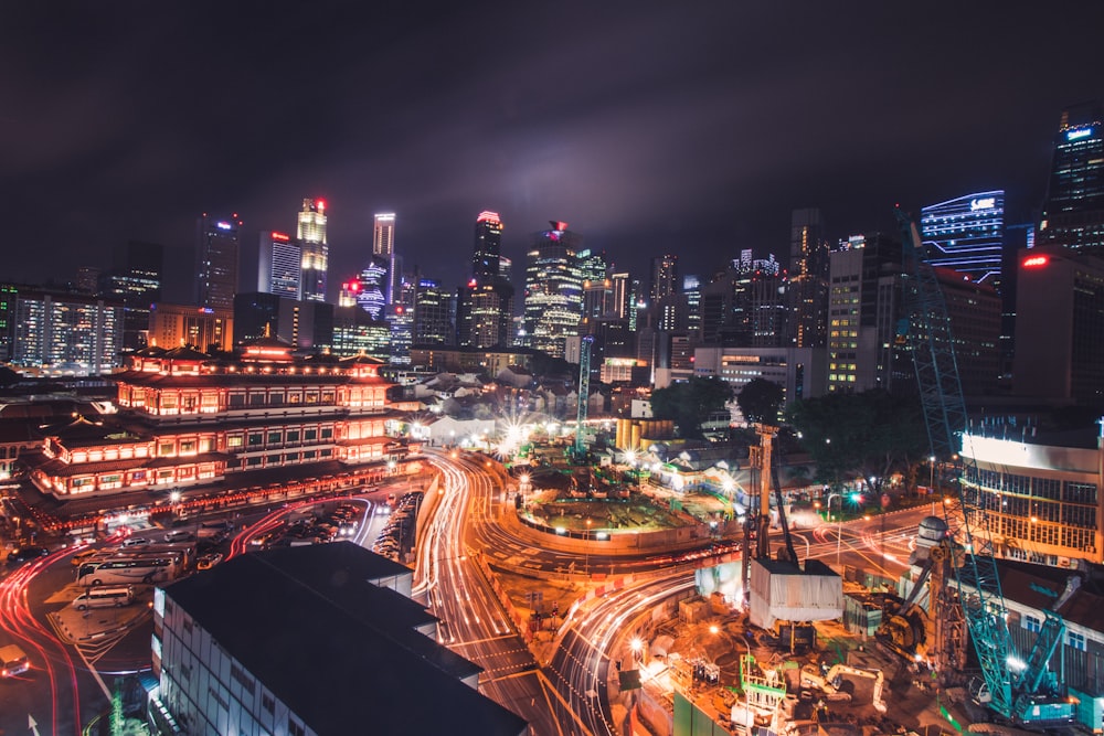 time-lapse photography of cityscape with vehicles at the road