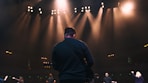 man playing guitar in concert