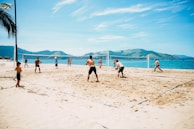 Group of competitors launching off the starting line on a sunny beach.