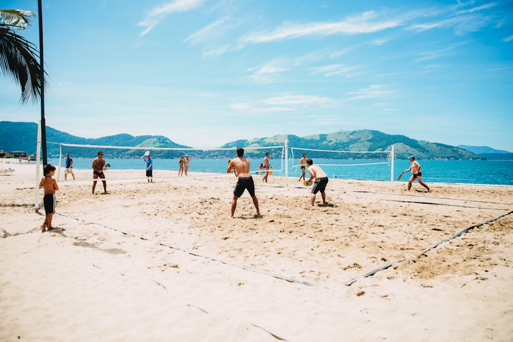 men playing volleyball on sand