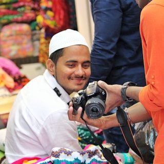 Behind-the-scenes moment of a creator collaborating with a top brand, smiling during a photo shoot.