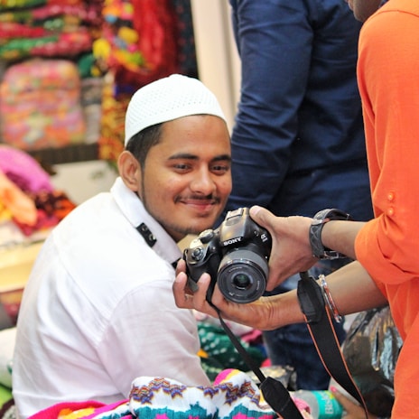 Behind-the-scenes moment of a creator collaborating with a top brand, smiling during a photo shoot.