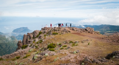 Group of travelers enjoying a scenic view from a mountain summit.